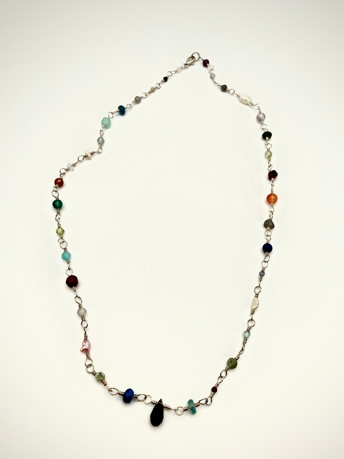 Necklace with multicolored beads on a white background
